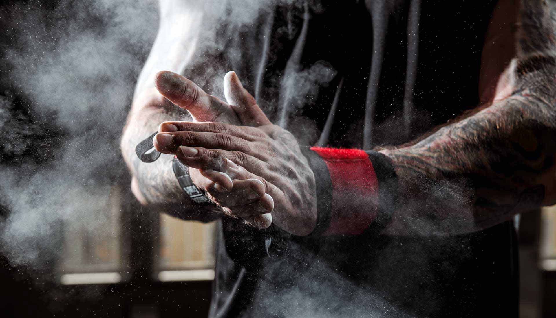 Male clapping with chalk getting ready for a pull up