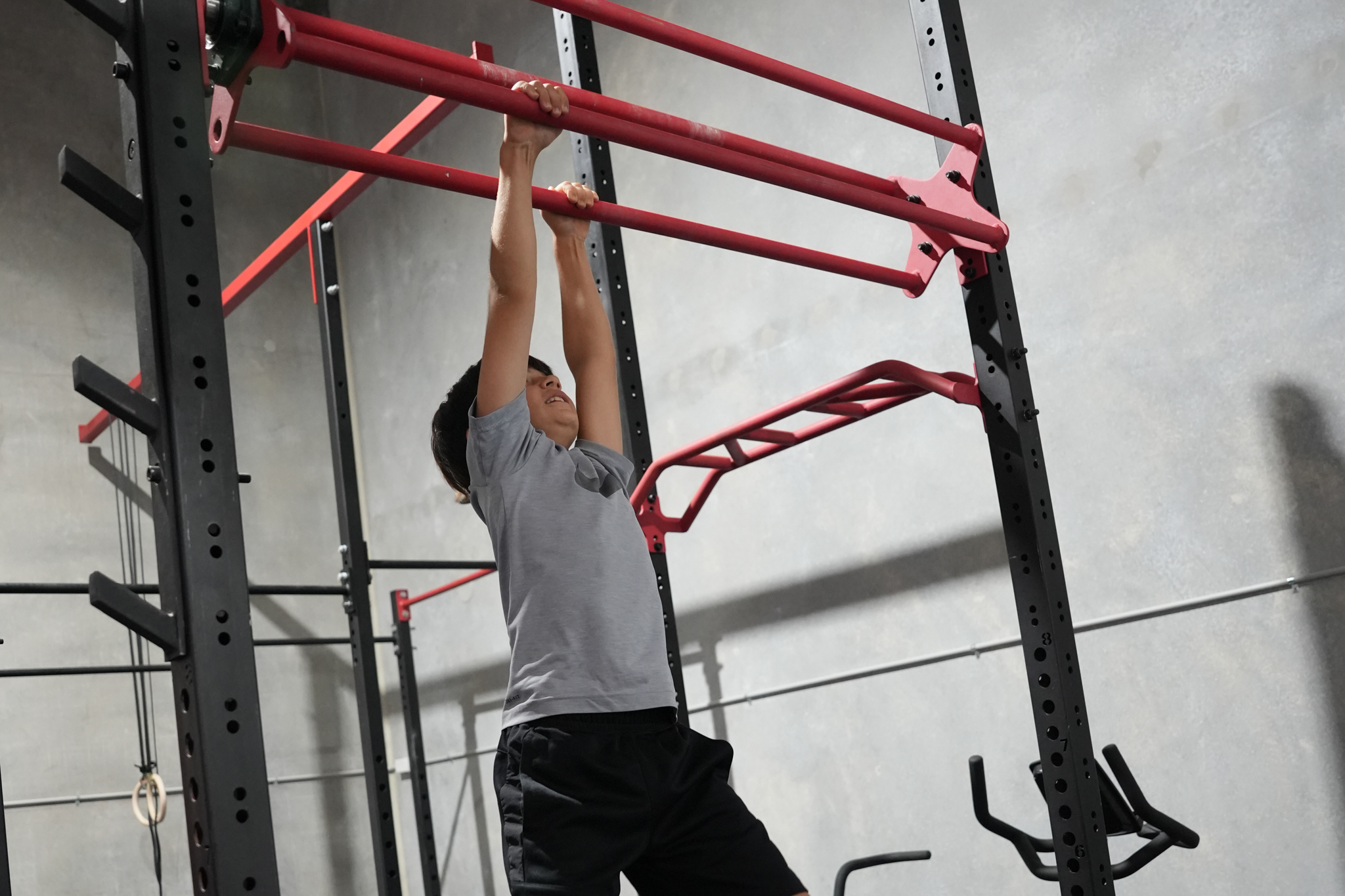 young kid doing infinity monkey bars
