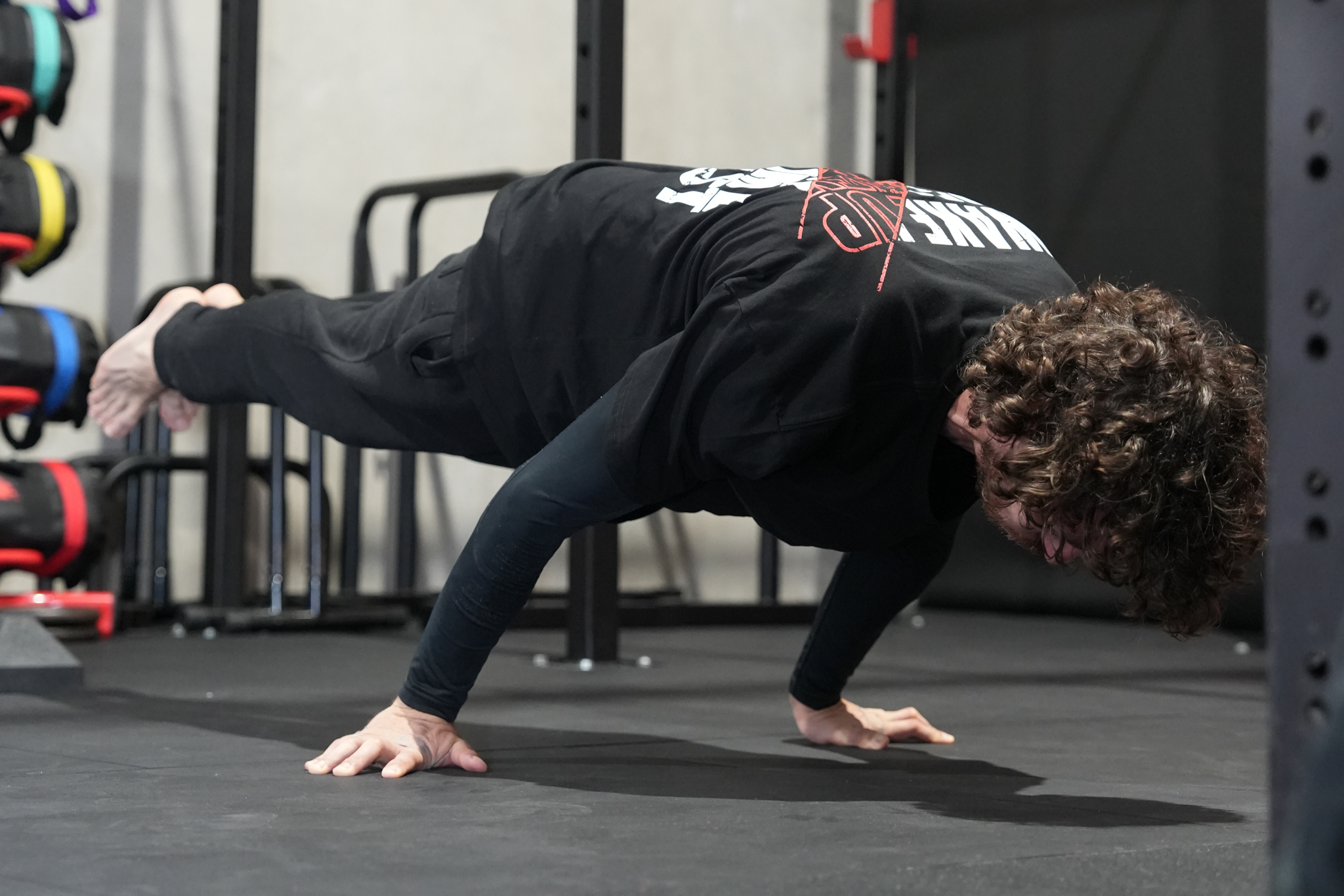 Guy doing Planche on gym floor